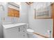 Clean, bright bathroom featuring a vanity with a marble countertop, a window, and wood trim at 4278 Harbor Ln, Sherrills Ford, NC 28673