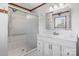 Modern bathroom featuring white cabinets, a large mirror, a shower with sliding glass doors, and updated fixtures at 4278 Harbor Ln, Sherrills Ford, NC 28673