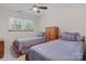Cozy bedroom with two twin beds, carpet, a ceiling fan, a window, and a wooden nightstand at 4278 Harbor Ln, Sherrills Ford, NC 28673