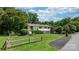 Inviting home showcasing a spacious lawn, split rail fence, and an asphalt driveway at 4278 Harbor Ln, Sherrills Ford, NC 28673