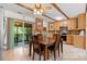 Traditional kitchen with wood cabinets, a ceiling fan, a dining table, and sliding doors leading to a screened-in porch at 4278 Harbor Ln, Sherrills Ford, NC 28673