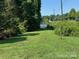 Expansive lawn leading to lake access, bordered by lush greenery and trees at 4278 Harbor Ln, Sherrills Ford, NC 28673