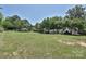 Large backyard with fence featuring a spacious lawn and mature trees at 5301 Addison Dr, Charlotte, NC 28211