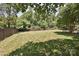 Fenced backyard showcasing expansive lawn and mature trees at 5301 Addison Dr, Charlotte, NC 28211
