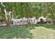 Backyard features a stone fireplace, patio, and outdoor dining area at 5301 Addison Dr, Charlotte, NC 28211