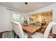 Open dining area with a wood table, views into the living room, and ample natural light at 5301 Addison Dr, Charlotte, NC 28211