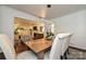 Inviting dining room featuring a wooden table, decorative rug, and an open view to a cozy living space at 5301 Addison Dr, Charlotte, NC 28211