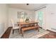 Elegant dining room with a rustic wood table, stylish lighting, and seating for six at 5301 Addison Dr, Charlotte, NC 28211