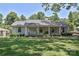 Classic brick home with a welcoming front porch, complemented by mature landscaping and lush lawn at 5301 Addison Dr, Charlotte, NC 28211