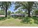 Spacious front yard with lush green grass and mature trees framing a charming home at 5301 Addison Dr, Charlotte, NC 28211