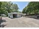 Exterior view of a brick detached garage featuring an open bay and wrought iron gated entry at 5301 Addison Dr, Charlotte, NC 28211