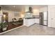 Open-concept kitchen flowing into a living area, featuring granite countertops and stainless steel appliances at 5301 Addison Dr, Charlotte, NC 28211