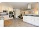 Spacious kitchen with a gas cooktop island, stylish white cabinetry, and modern stainless steel appliances at 5301 Addison Dr, Charlotte, NC 28211