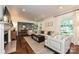 Open-concept living room with hardwood floors, neutral tones, and a view into the dining area at 5301 Addison Dr, Charlotte, NC 28211