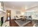 Inviting living room with hardwood floors, a cozy fireplace, and an open layout to the dining area at 5301 Addison Dr, Charlotte, NC 28211