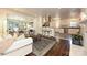 Bright living room flows into kitchen featuring hardwood floors, stylish seating, and an inviting open layout at 5301 Addison Dr, Charlotte, NC 28211