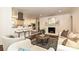 Bright living room featuring a fireplace and an open layout to the kitchen with barstool seating at 5301 Addison Dr, Charlotte, NC 28211