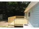 New wooden back deck features wood railings and stairs, attached to a light blue house on a gravel backyard at 561 Woodglenn Rd, Catawba, SC 29704