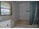Bright bathroom features a shower-tub combo with a shower curtain, window with blinds, and a sink with vanity at 561 Woodglenn Rd, Catawba, SC 29704