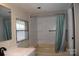 Bright bathroom featuring a shower-tub combo with a shower curtain, window with blinds, and a sink with a mirror at 561 Woodglenn Rd, Catawba, SC 29704
