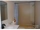 Bathroom featuring a sink with vanity, a mirror, a window, toilet with cleaning supplies, and a shower-tub combo at 561 Woodglenn Rd, Catawba, SC 29704