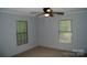 Bedroom featuring carpeted floors, ceiling fan, and natural light from two windows at 561 Woodglenn Rd, Catawba, SC 29704