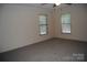 A clean bedroom features neutral walls, carpeted floors, two windows for natural light, and a ceiling fan at 561 Woodglenn Rd, Catawba, SC 29704