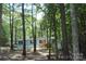 Charming single-story home features a classic facade with inviting front porch and lush, wooded surroundings at 561 Woodglenn Rd, Catawba, SC 29704