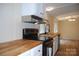 Close-up of the kitchen's wood countertop, black appliances, white cabinets, and stainless steel vent hood at 561 Woodglenn Rd, Catawba, SC 29704