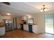 Bright kitchen features white cabinets, stainless steel appliances, wood countertops, hardwood style floors, and sliding door access at 561 Woodglenn Rd, Catawba, SC 29704