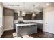 Stylish kitchen island with gray cabinetry, sleek countertops, and modern pendant lighting at 6140 Balham Ct # Ken0059, Charlotte, NC 28215