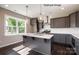 Kitchen island features gray cabinets, quartz countertops, and stainless steel appliances at 6140 Balham Ct # Ken0059, Charlotte, NC 28215
