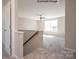 Bright loft area with a ceiling fan, a staircase with wooden railing, carpet floors and natural light at 6140 Balham Ct # Ken0059, Charlotte, NC 28215