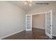 An office space with dark wood flooring, white trim, and light-colored walls at 6140 Balham Ct # Ken0059, Charlotte, NC 28215