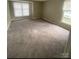 Spacious bedroom with plush carpeting, large windows, and plenty of natural light at 6260 Rosecroft Dr, Charlotte, NC 28215