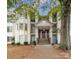 Inviting condo exterior features a covered entrance, stairs, and well-maintained landscaping at 6260 Rosecroft Dr, Charlotte, NC 28215