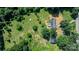 Aerial view showing the home, detached garage, and yard, surrounded by sprawling greenery and trees at 6314 Providence Church Rd, Vale, NC 28168
