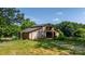 A rustic barn provides ample storage or workshop space, set amidst a backdrop of mature trees at 6314 Providence Church Rd, Vale, NC 28168