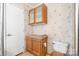 Full bathroom with traditional vanity, toilet, and updated wall coverings at 6314 Providence Church Rd, Vale, NC 28168
