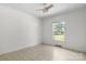 Bright bedroom features a ceiling fan, vinyl flooring and a window overlooking an outdoor area at 6314 Providence Church Rd, Vale, NC 28168