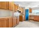 Cozy kitchen features wood cabinets, a blue door and plenty of natural light at 6314 Providence Church Rd, Vale, NC 28168