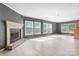 Spacious living room boasts a decorative fireplace and large windows offering natural light at 6314 Providence Church Rd, Vale, NC 28168