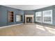 A spacious living room features a decorative fireplace, natural light, and additional shelving space at 6314 Providence Church Rd, Vale, NC 28168