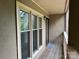 A covered outdoor balcony with wood flooring and a view of foliage at 633 Portside Dr, Davidson, NC 28036