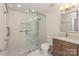 This renovated bathroom features a glass shower with a decorative tile inlay and updated fixtures at 633 Portside Dr, Davidson, NC 28036