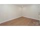 This freshly painted bedroom features hardwood floors and crisp, white trim at 633 Portside Dr, Davidson, NC 28036