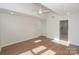 Bedroom featuring hardwood floors, neutral walls, ceiling fan and an ensuite bath with glass shower at 633 Portside Dr, Davidson, NC 28036