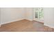 Bright bedroom features hardwood floors, fresh paint and a sun-drenched window at 633 Portside Dr, Davidson, NC 28036