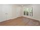 Bedroom with hardwood floors features large closets and triple window with natural light at 633 Portside Dr, Davidson, NC 28036