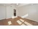 Spacious bedroom with hardwood floors, neutral walls, and a bathroom entrance at 633 Portside Dr, Davidson, NC 28036